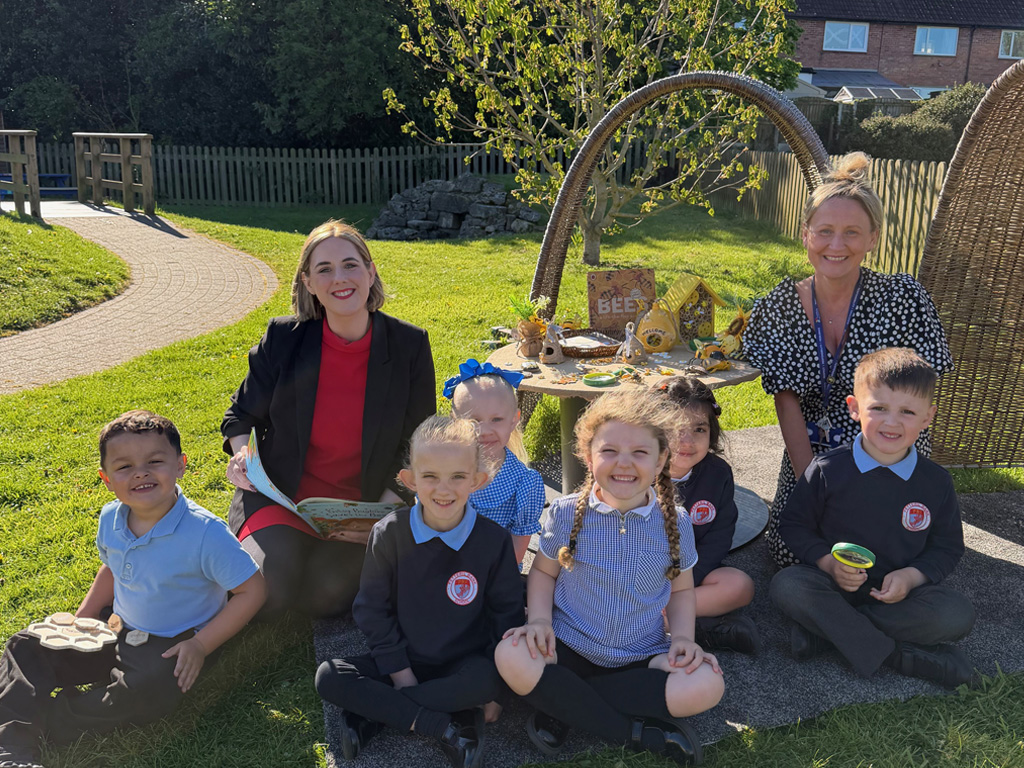 Teachers and pupils sitting outside at Petteril Bank School